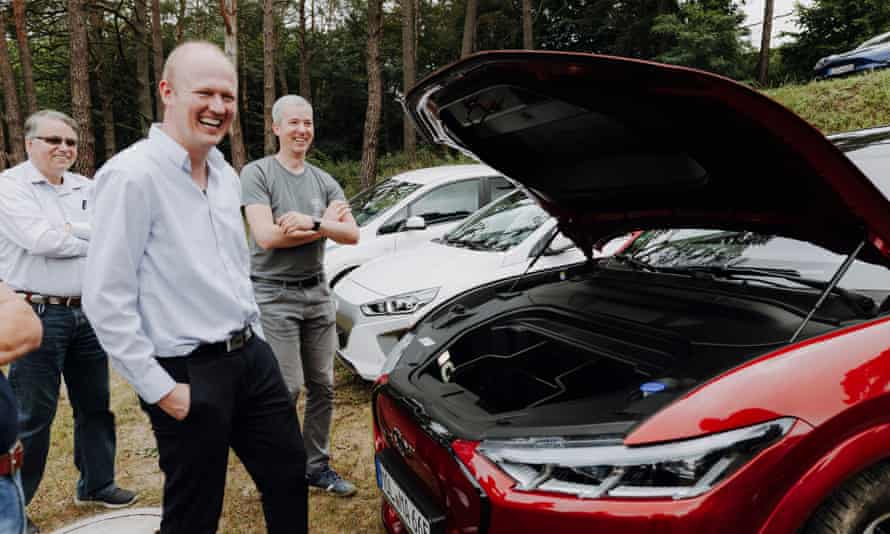 Enthusiasts check out an electric car