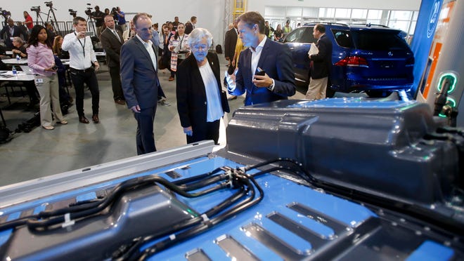 Gov. Kay Ivey, center, views a general model of a battery as Markus Schaefer, head of production planning, explains how it will be used in future electric cars produced at Mercedes-Benz U.S. International during the 20-year celebration at MBUSI in the 167 body shop at the plant in Vance on Thursday, Sept. 21, 2017. .  [Staff Photo/Erin Nelson]