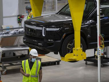 Vehicles are assembled and tested on April 14 at the Rivian plant in Normal, Ill. Rivian pushed its production launch back to September, in part because of the semiconductor chip shortage roiling the auto industry.