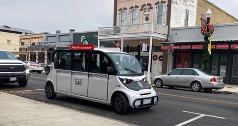 Photo of an electric taxi in a rural downtown