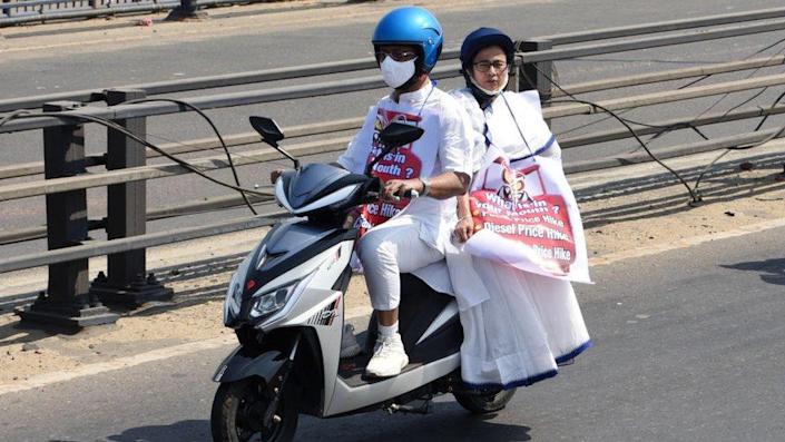 West Bengal Chief Minister Mamata Banerjee rides pillion on an electric scooter to reach State Secretariat Nabanna to protest against fuel price hike.