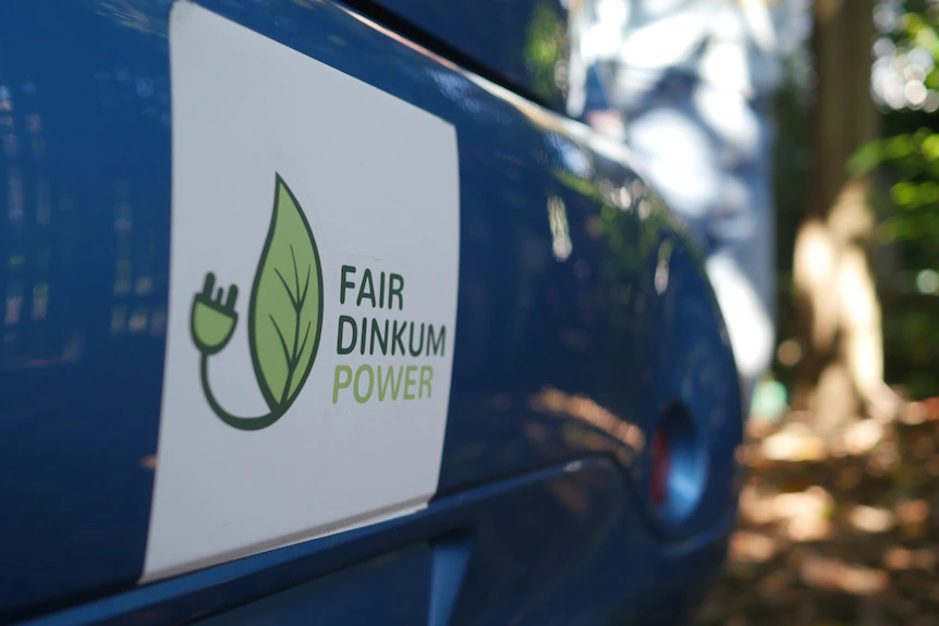 A blue car with a logo for Fair Dinkum Power on the side. 