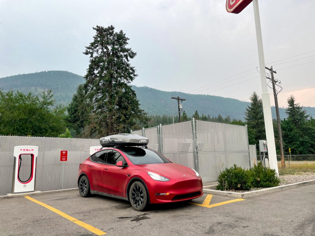 Electric car parked at charging station in parking lot