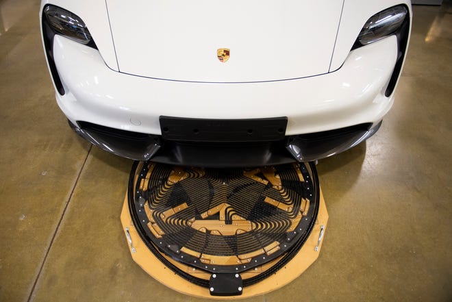 A wireless electric vehicle charger sits under a Porsche at GRID-C at Oak Ridge National Laboratory's Hardin Valley campus.