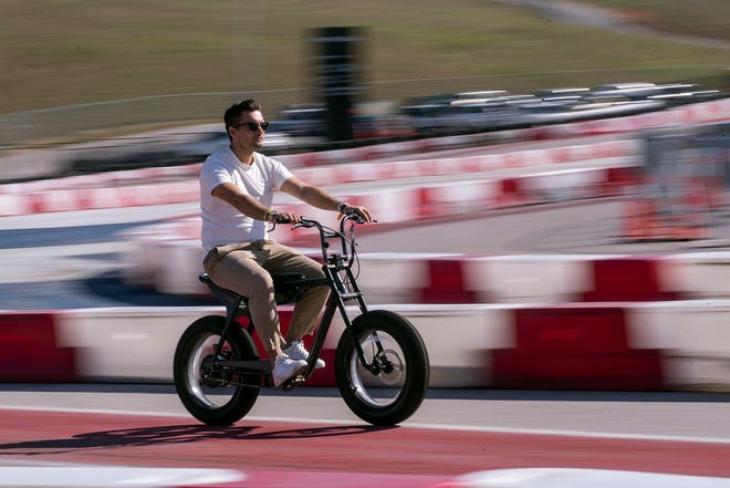 A man rides an e-bike on the demo track during the Electrify Expo at Circuit of the Americas in November, 2021. The event is North America's largest electric vehicle festival.